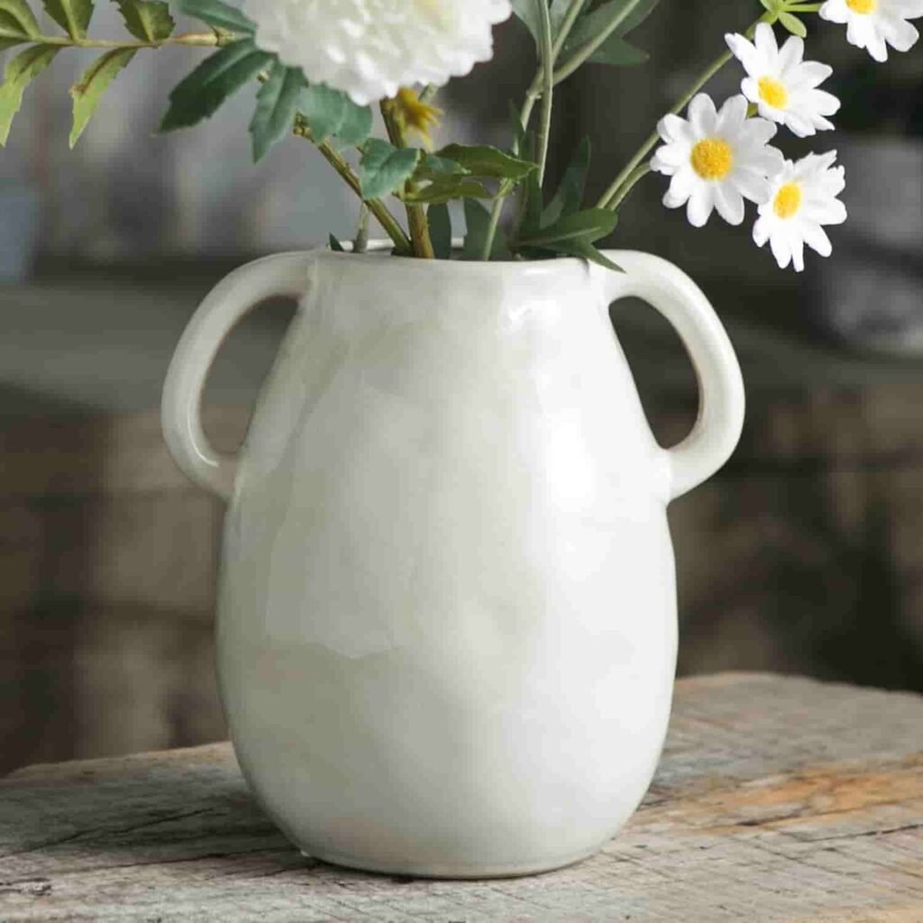 white cermaic vase with handles